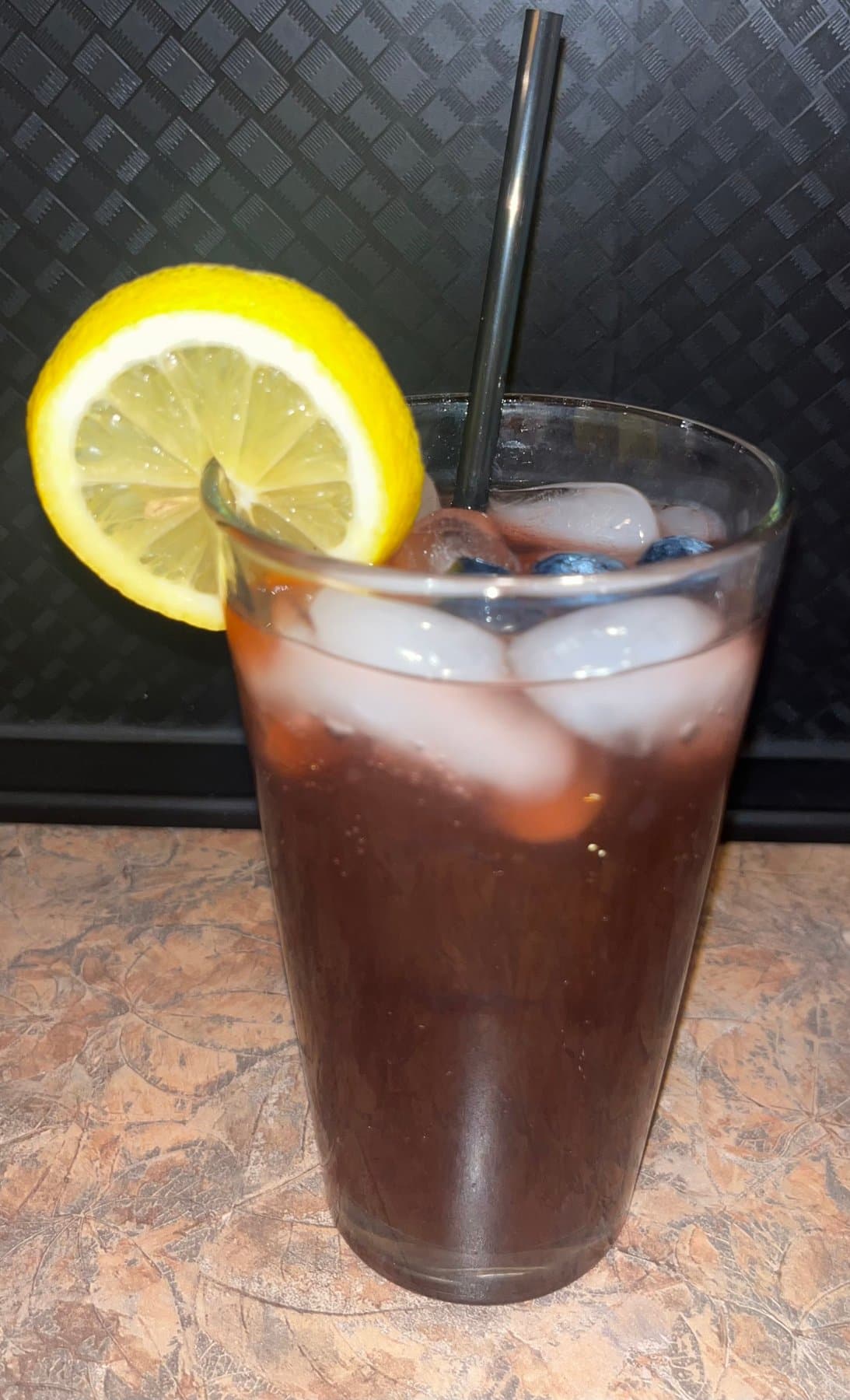 Trauma Tonic mocktail with blueberry syrup and lemon